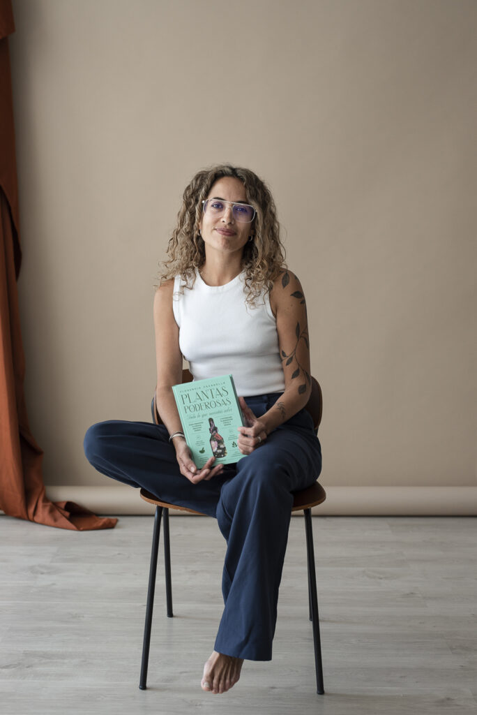 Florencia Fasanella, directora de la Academia Florecer, sosteniendo el libro Plantas Poderosas